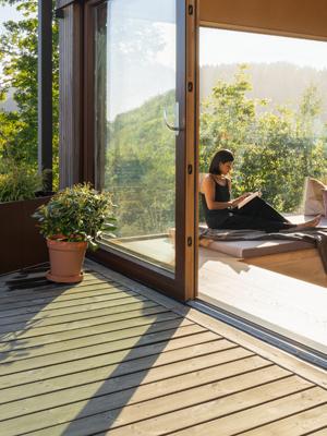 Girl sitting in a sun room off a deck